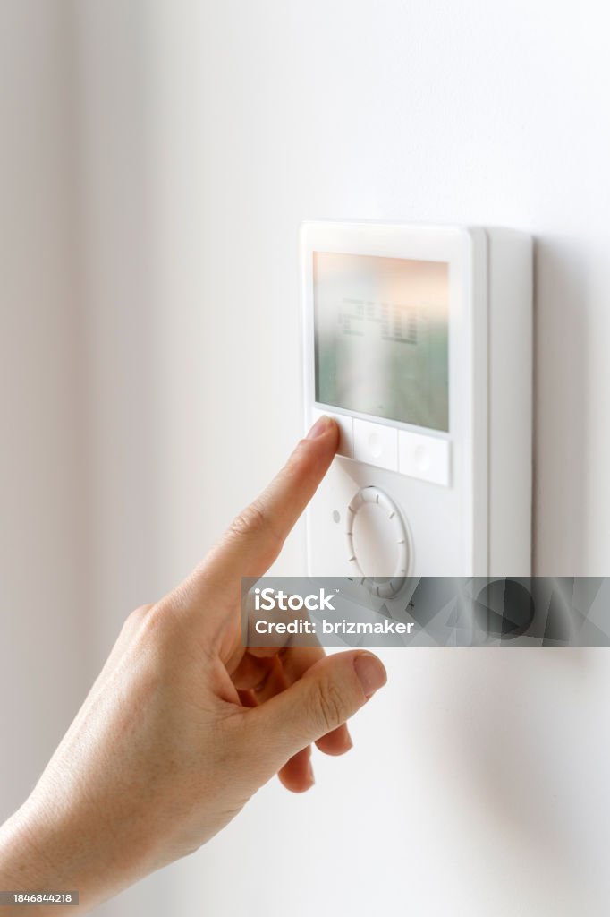 Hand putting wall insulation into a cabity wall